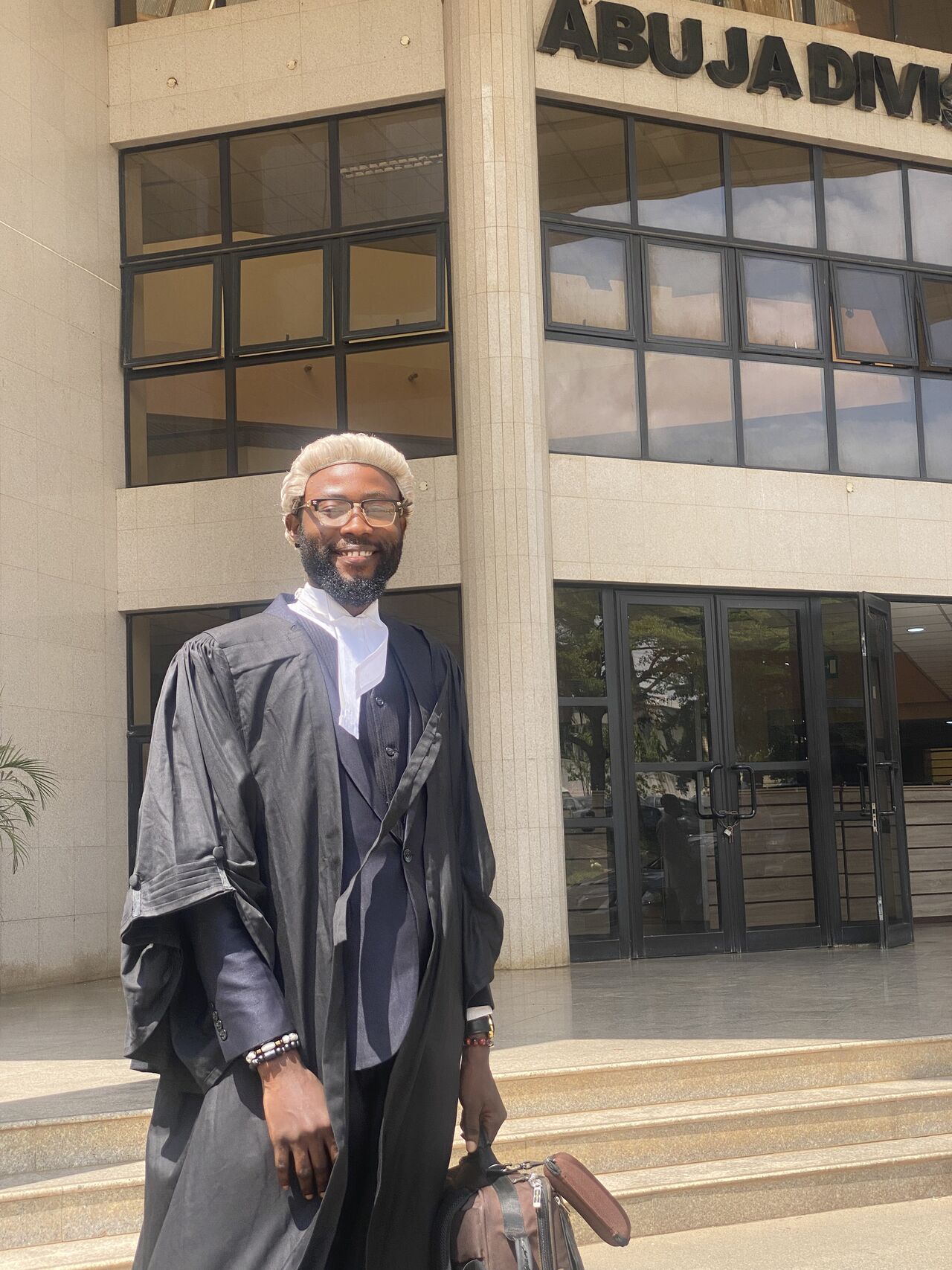 Prince Ezeabata Chibuzor in legal attire outside the Abuja division court building